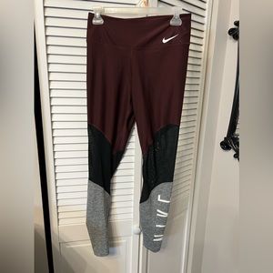 Maroon Nike leggings with logo down the leg